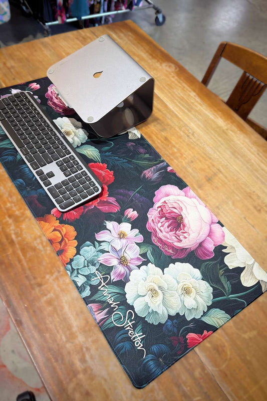 Floral desk mat with keyboard on a wooden desk