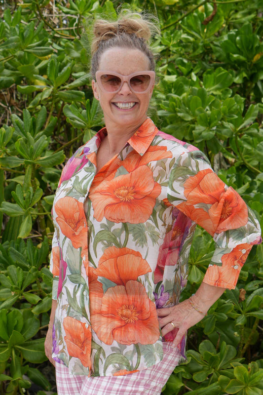 Woman wearing bold floral button-up shirt – Annah Stretton fashion