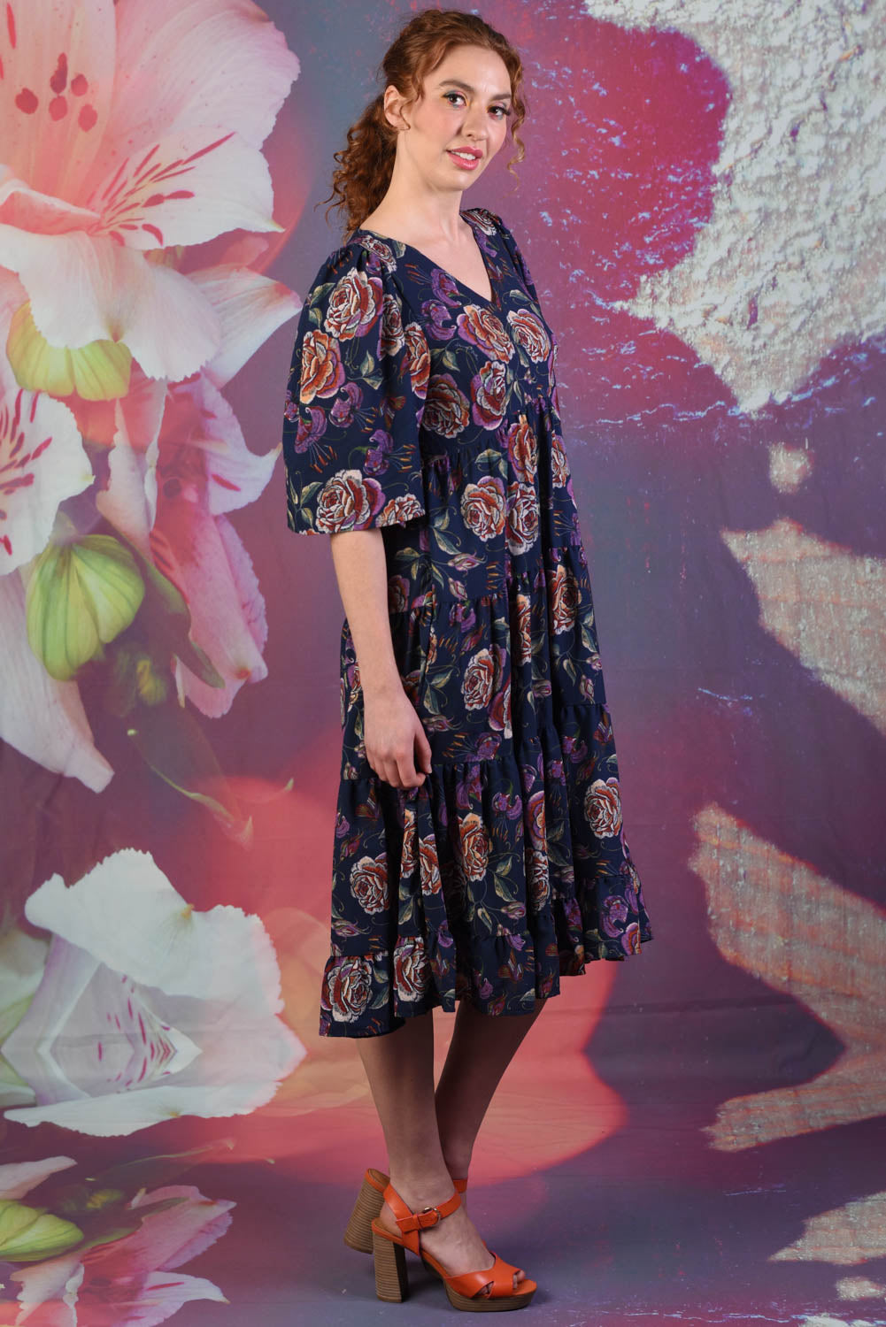 Side of model wearing the Magic Ari dress in navy floral by Annah Stretton
