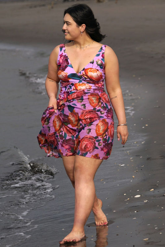 A person wearing a lilac roses swim scarf wrap by the beach.