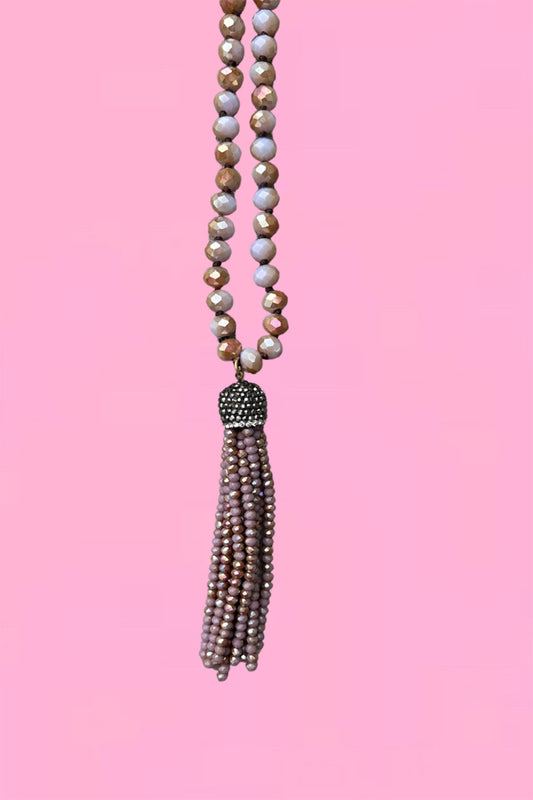 Close-up of the mauve Annah Stretton Crystal Tassel necklace
