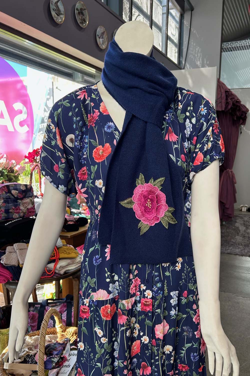 The Annah Stretton Freya Cashmere Scarf in navy on a mannequin