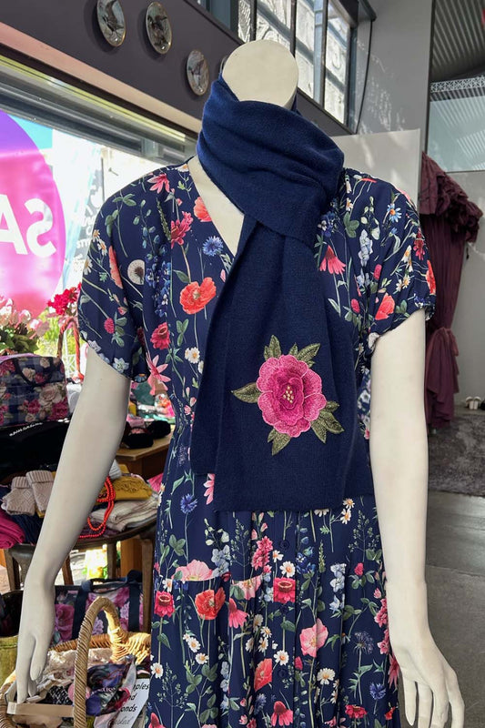 The Annah Stretton Freya Cashmere Scarf in navy on a mannequin