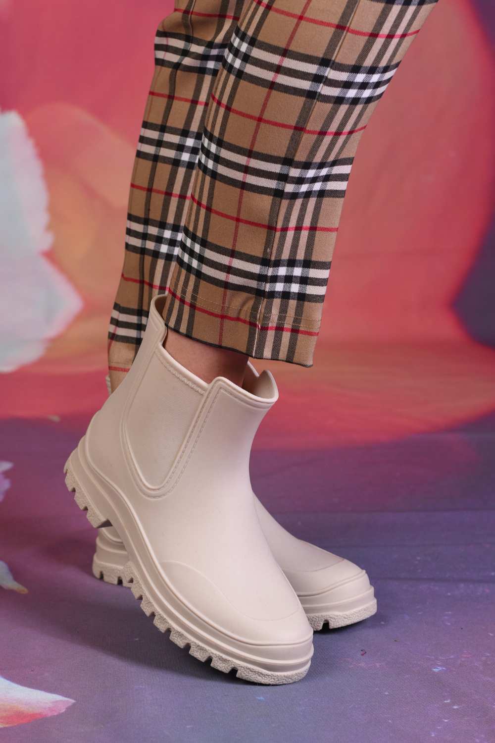 Model wearing the Annah Stretton Mickey Gumboot in cream