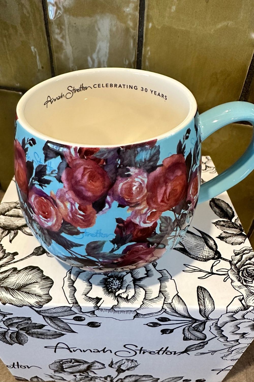 Close-up of the writing and rose floral detail on the mug