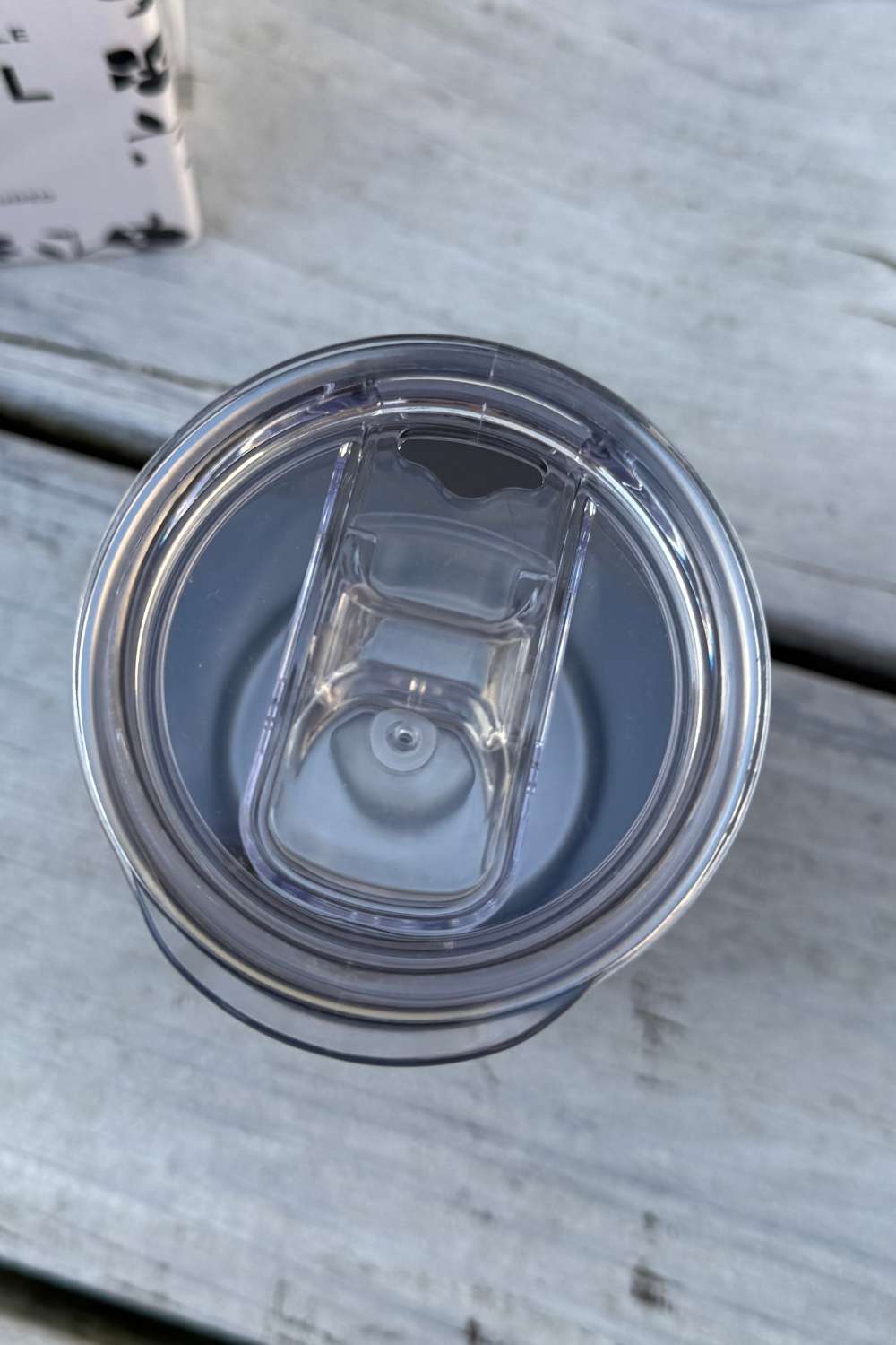 Clear plastic lid on a wooden surface