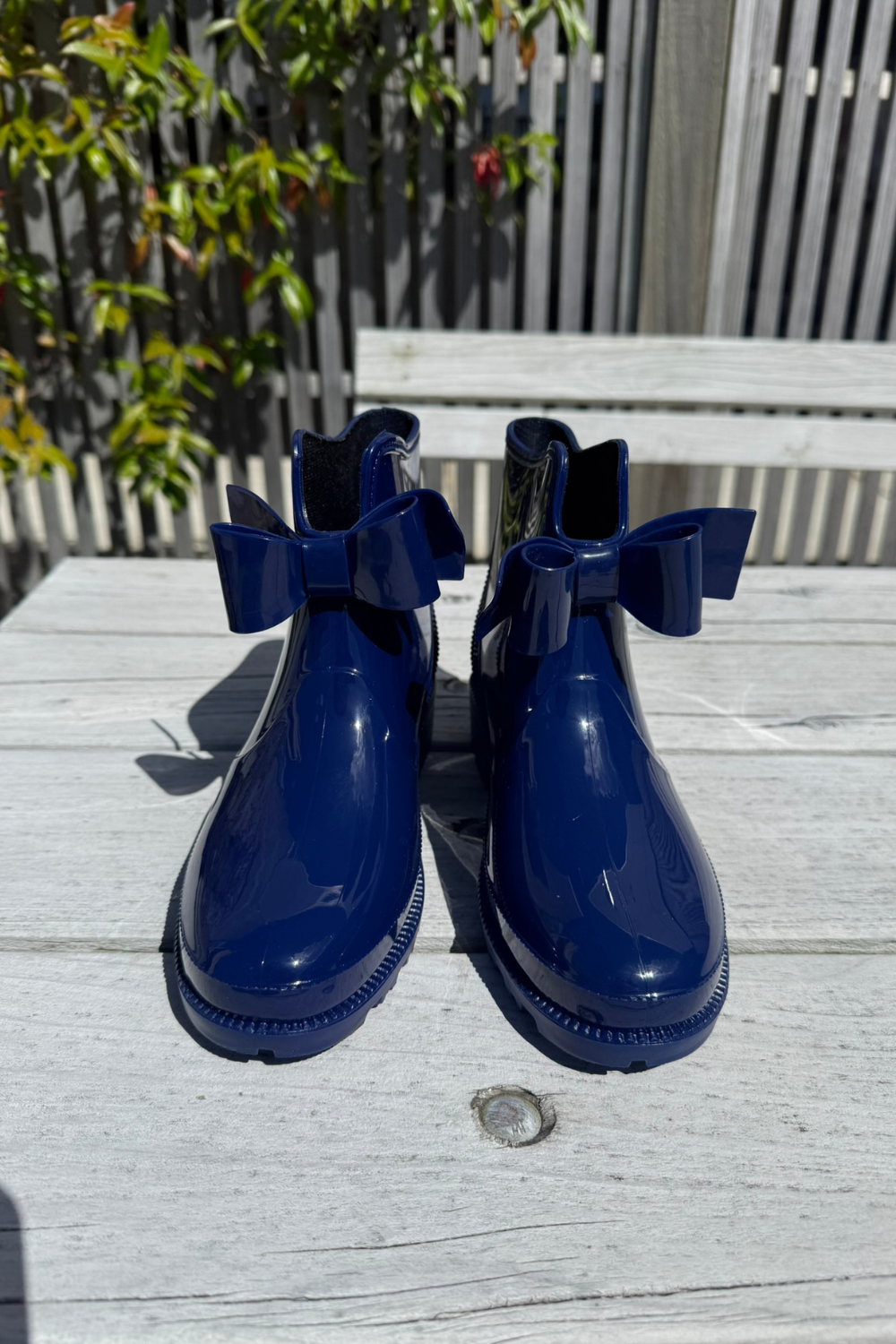 Pair of blue rain boots with bow details 