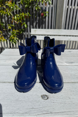 Pair of blue rain boots with bow details 