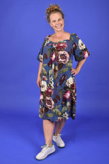 Woman wearing a floral dress against a blue background