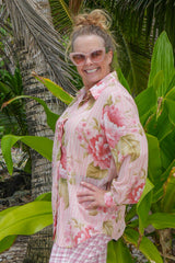 Woman wearing pink floral cotton button-up shirt