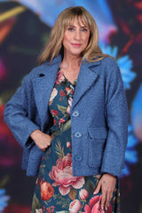 Cropped winter jacket over floral dress