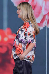 Rosewater floral blouse with gartered short sleeves and gathered neckline styled with navy pinstripe pants