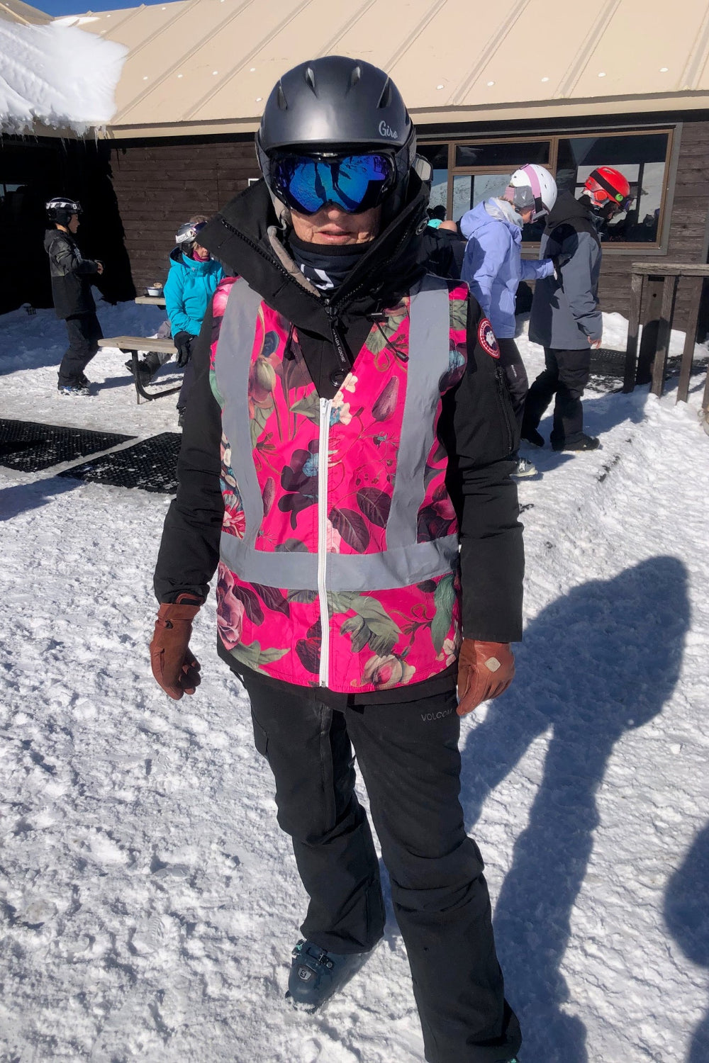 floral hi-vis vest on black clad skiier