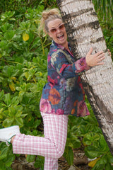 Person in colorful top and pink pants 