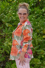 Woman wearing bold floral button-up shirt – Annah Stretton fashion