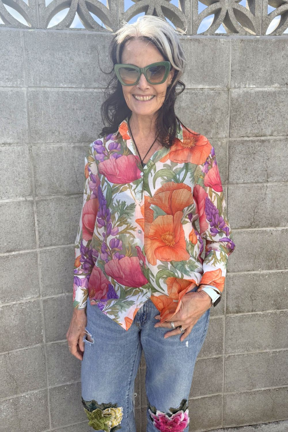 Woman wearing bold floral button-up shirt – Annah Stretton fashion
