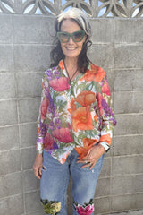 Woman wearing bold floral button-up shirt – Annah Stretton fashion