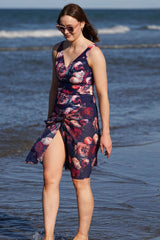 Model wearing navy floral tankini swimsuit at beach