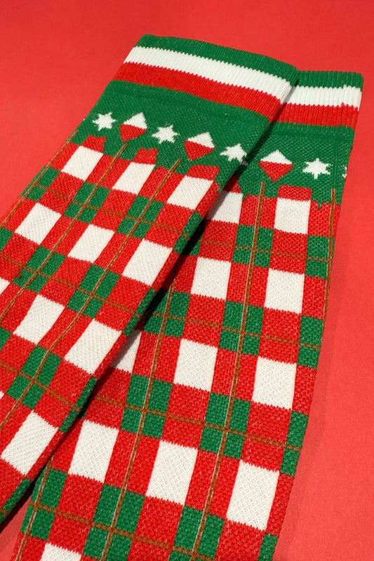 Red, green, and white checkered socks on a red background
