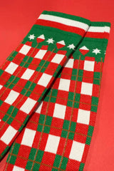 Red, green, and white checkered socks on a red background