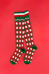 Red and green checkered socks on a red background