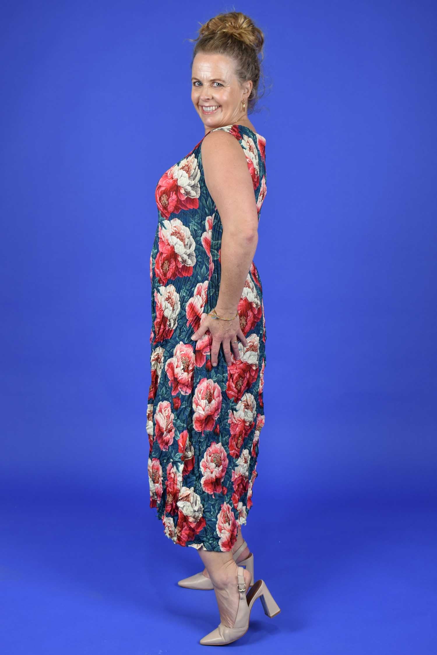 Woman wearing a floral dress against a blue background