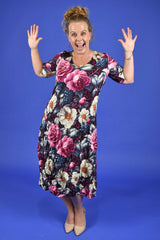 Woman wearing a floral dress against a blue background