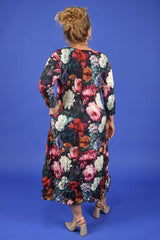 Woman wearing a floral dress against a blue background