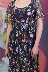 Close-up of the embroidered flower designs on the Nicole dress