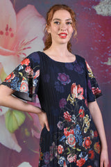 Close-up of model wearing the Annah Stretton Pleat Me Dress in Dahlia