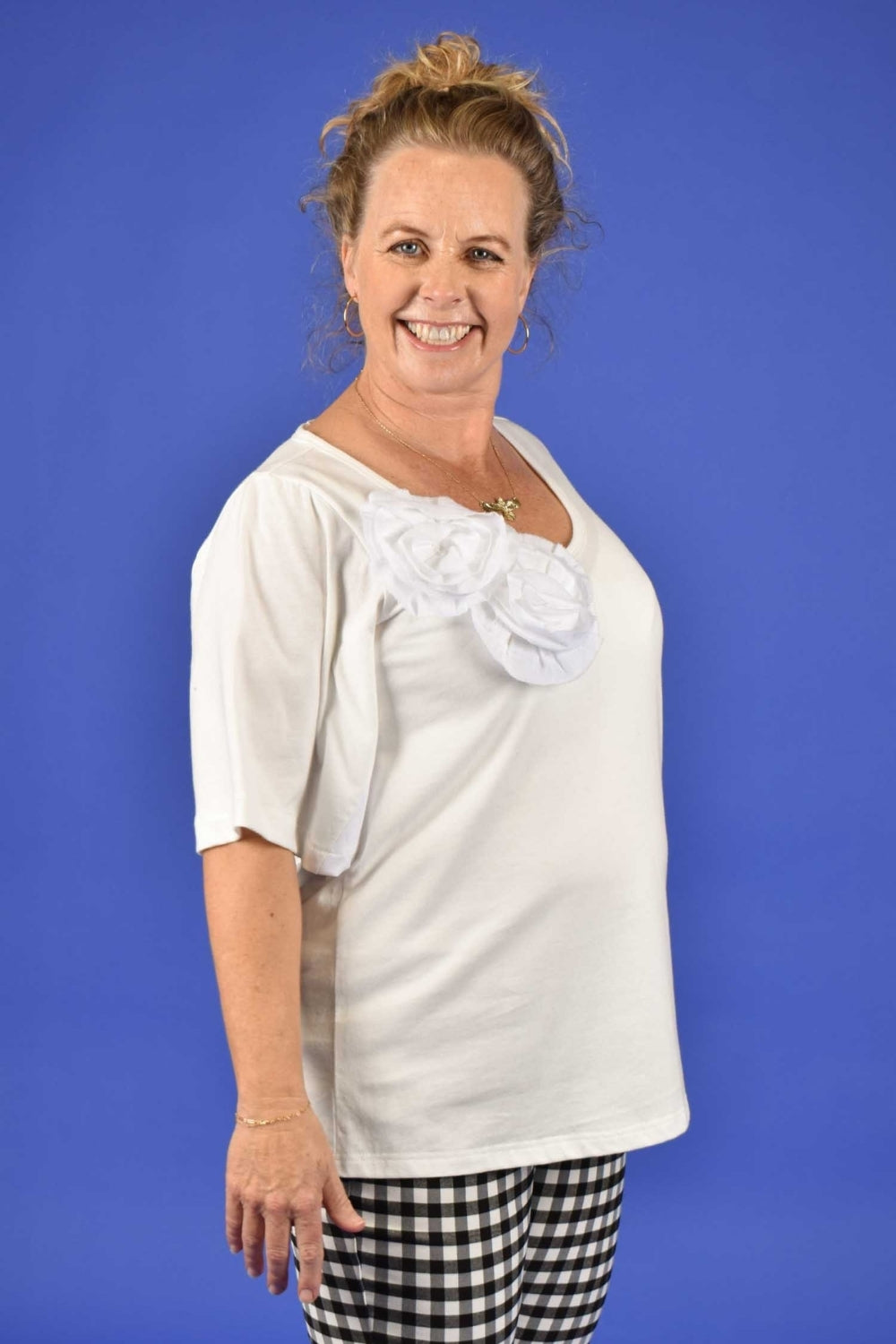 Side view of Prized Cotton Tee – women’s oversized white top.