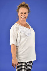 Side view of Prized Cotton Tee – women’s oversized white top.