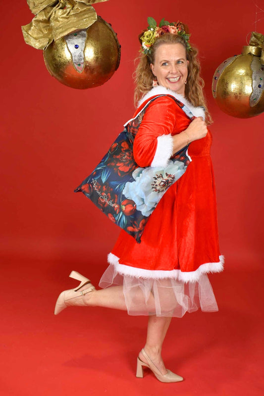 Woman holding eco-friendly Merry Bloom reusable shopping bag – festive tote