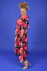 Side view of floral occasion dress with pockets by Annah Stretton