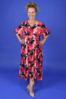 Woman wearing a floral dress against a blue background