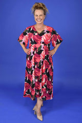 Woman wearing a floral dress against a blue background