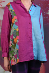 Close-up of the Annah Stretton Wylie Joi shirt, showing a split colour-block of magenta and light blue, with a multi-coloured heart print on the side