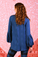 model wearing Renne Rose slate blue top