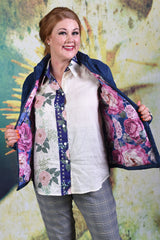 Model showing interior or Ambrosia Puffer jacket showing a navy and pink peony print