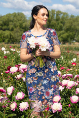 model wearing floral lace dress in cobalt by annah stretton