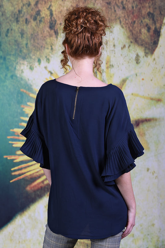 Back of model wearing the Annah Stretton Dayna Top in plain navy