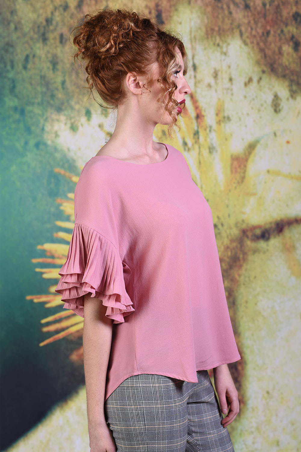 Side of model wearing the Annah Stretton Dayna top in plain pink