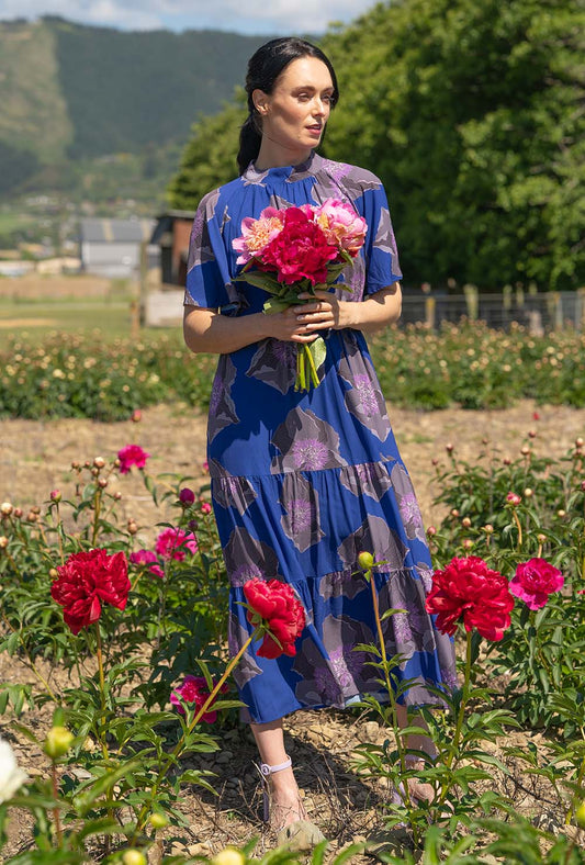model wearing marigold dress in navy by annah stretton