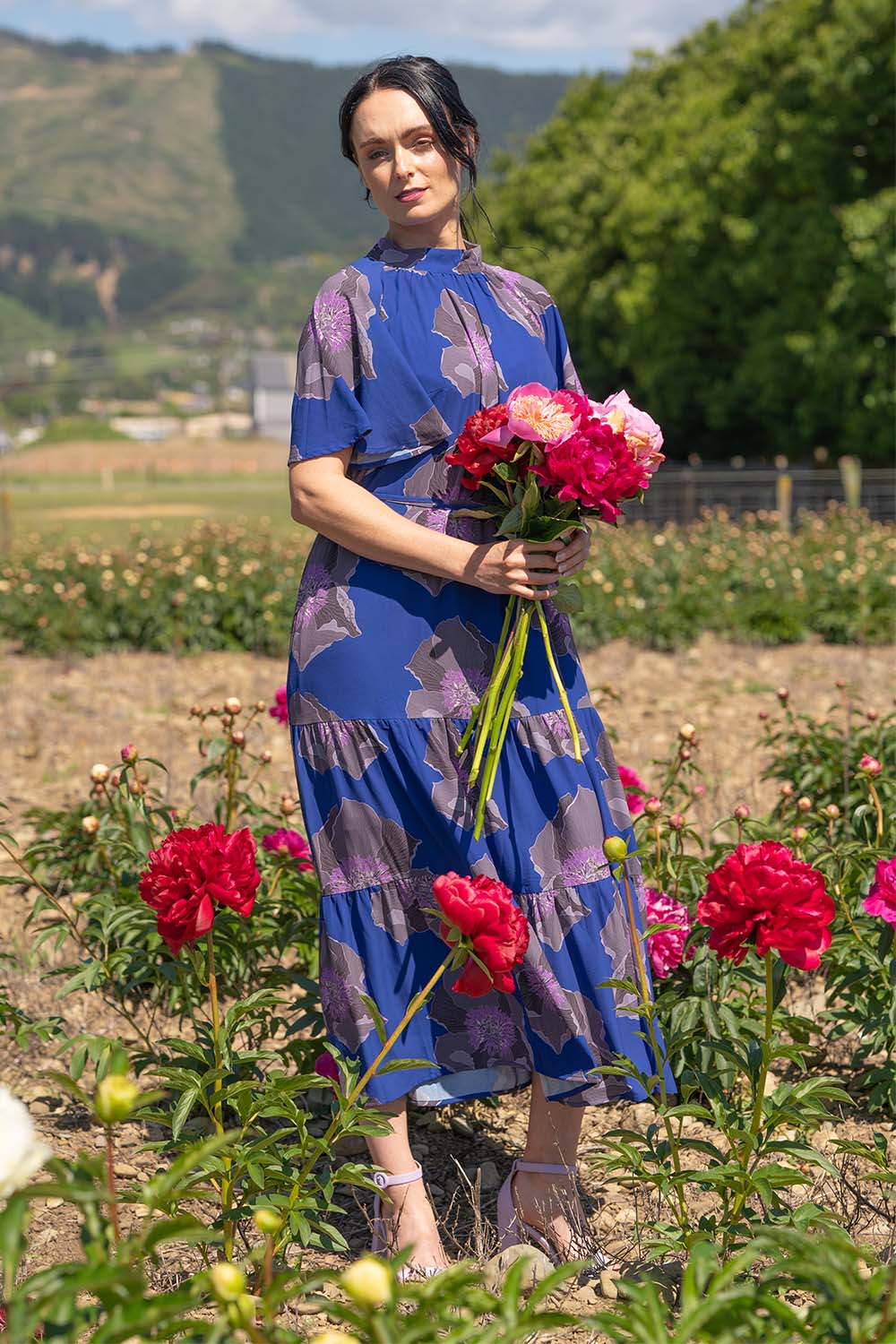 model wearing midi length marigold dress by annah stretton
