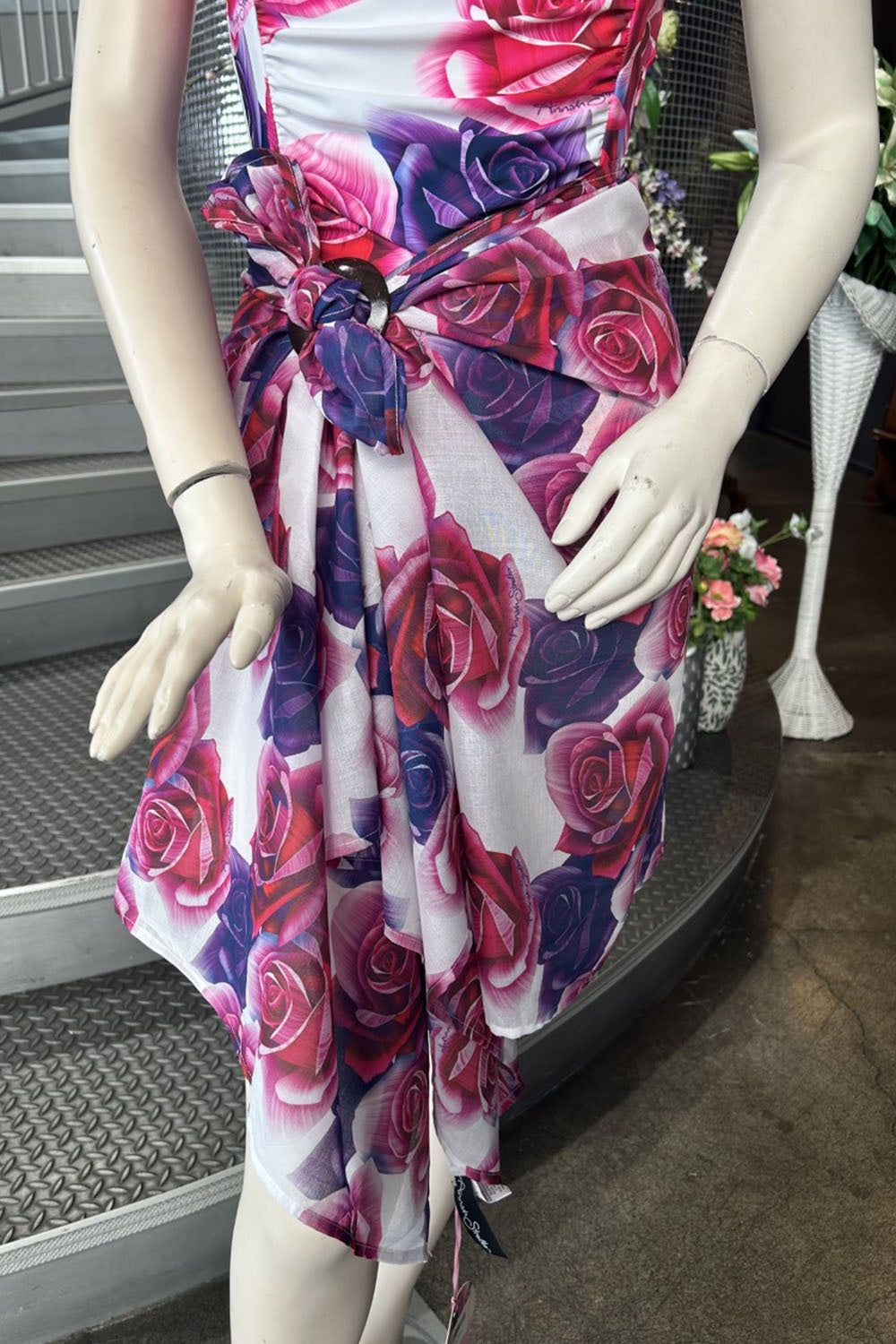 Close-up showing the pink and purple rose design atop a white background