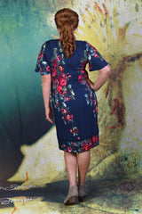 Back of second model wearing the Pleat Me Juliet dress in rose, with hand on hip.