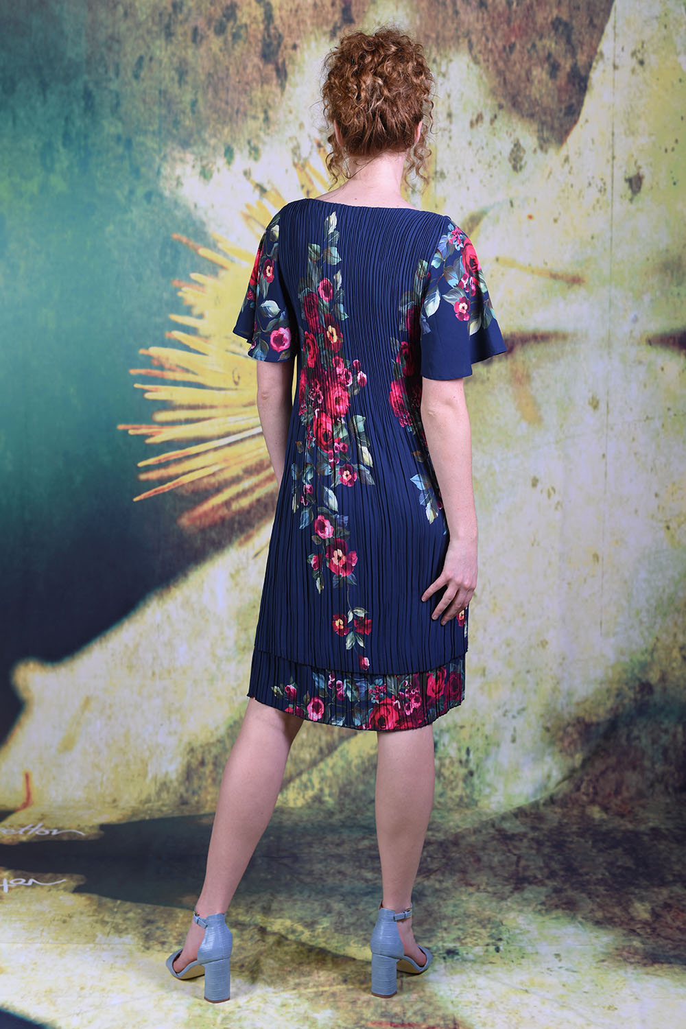 Back of model wearing the Annah Stretton Pleat Me Dress in rose