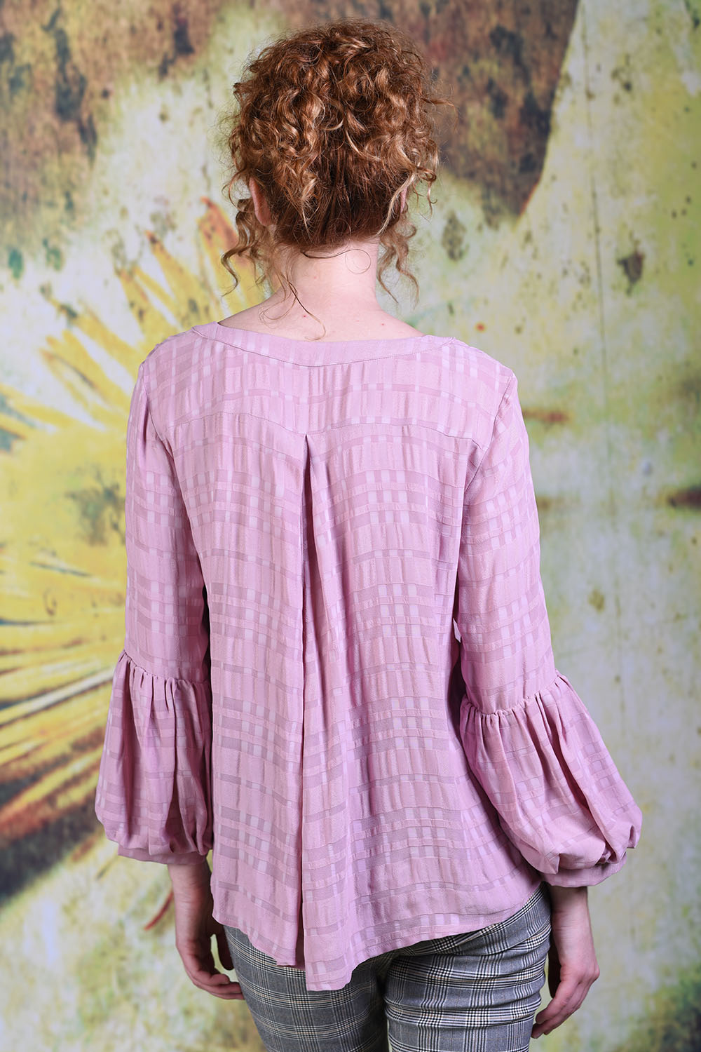 Back of model wearing the Annah Stretton Poison Ivy top in dusky pink