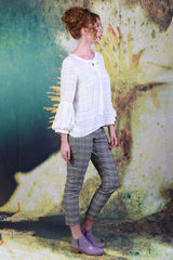Model wearing the Cream Poison Ivy top facing the right