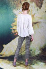 Full-body shot of model facing the back wearing the Poison Ivy Top in the cream